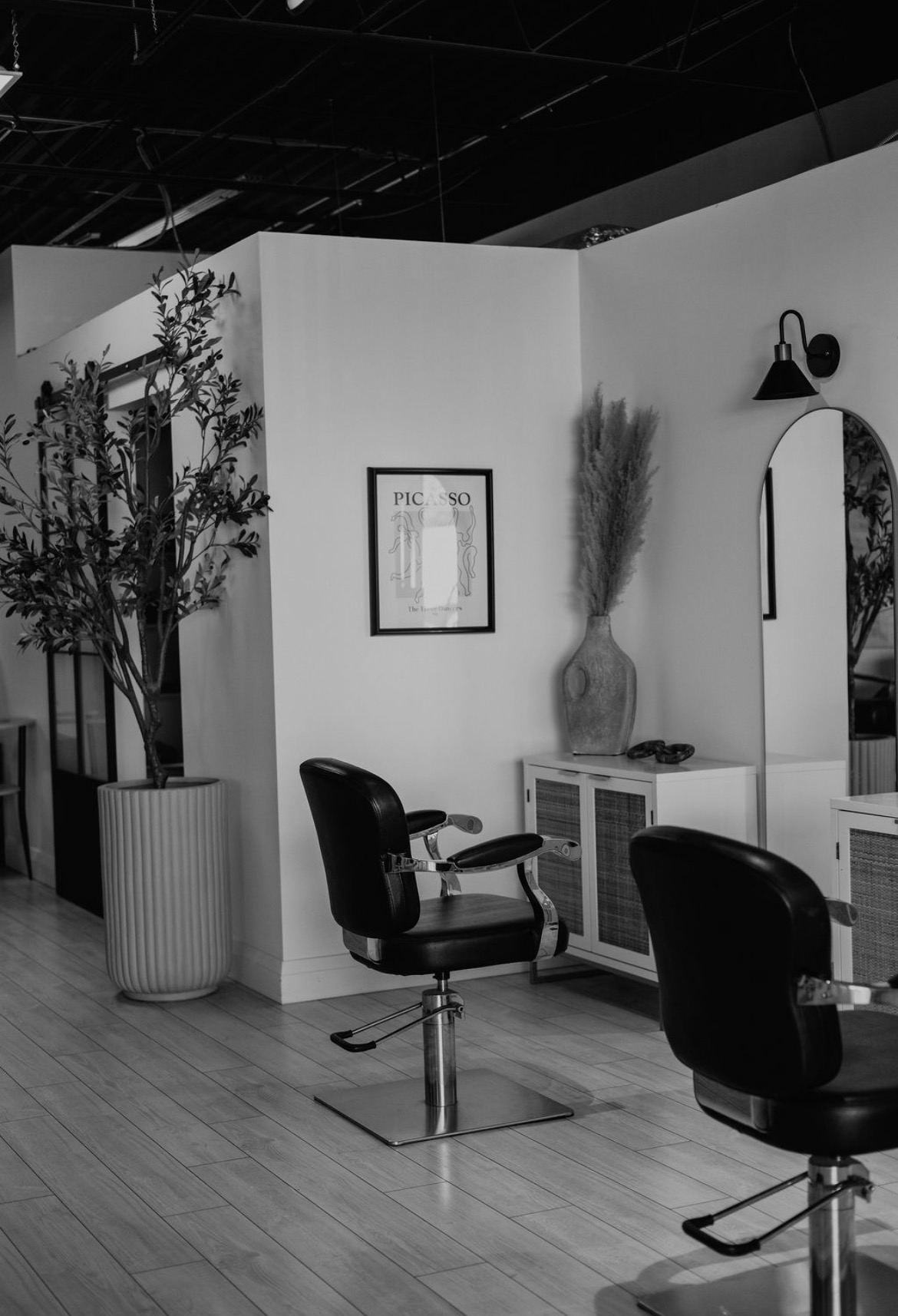 A styling chair beside greenery