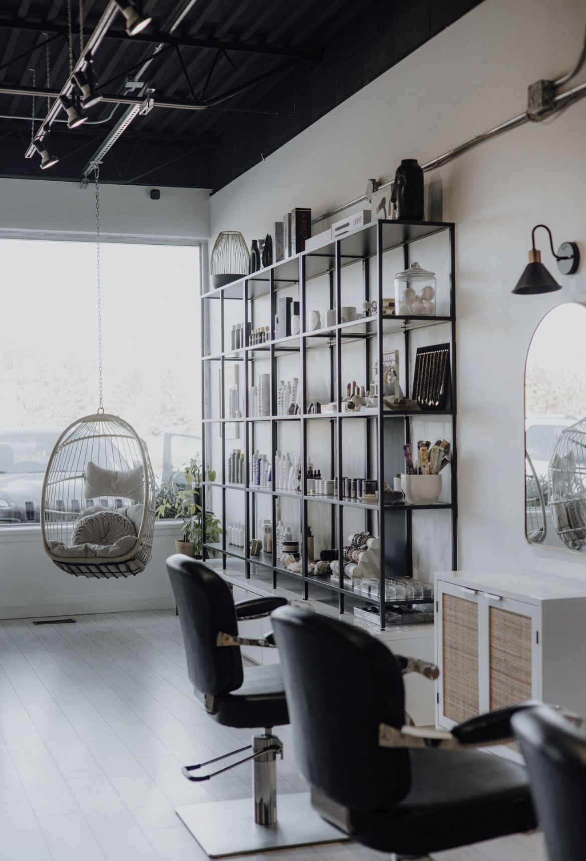 The studio floor with hanging chair and open shelving